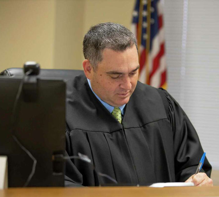 Attorney Paul Damico in judge's robes in court